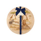 Round beech wood chopping board featuring a watercolour design of safari animals in the African savannah. The wooden board is finished with a blue gift ribbon and tag.