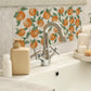 A luxurious bathroom sink with a 20x40cm cream marble splash back tile with a watercolour oranges and leaves pattern.