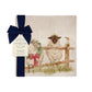 A medium marble platter featuring a watercolour illustration of sheep in the snow wearing a Christmas wreath. The platter is wrapped with a navy blue bow and paper tag.