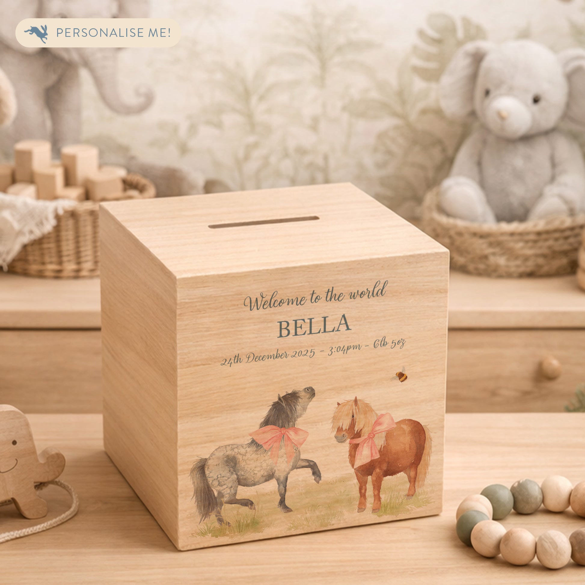 personalised handmade wooden money box for christening nursery decor, Shetland ponies playing with bunting and bows around their neck. 
