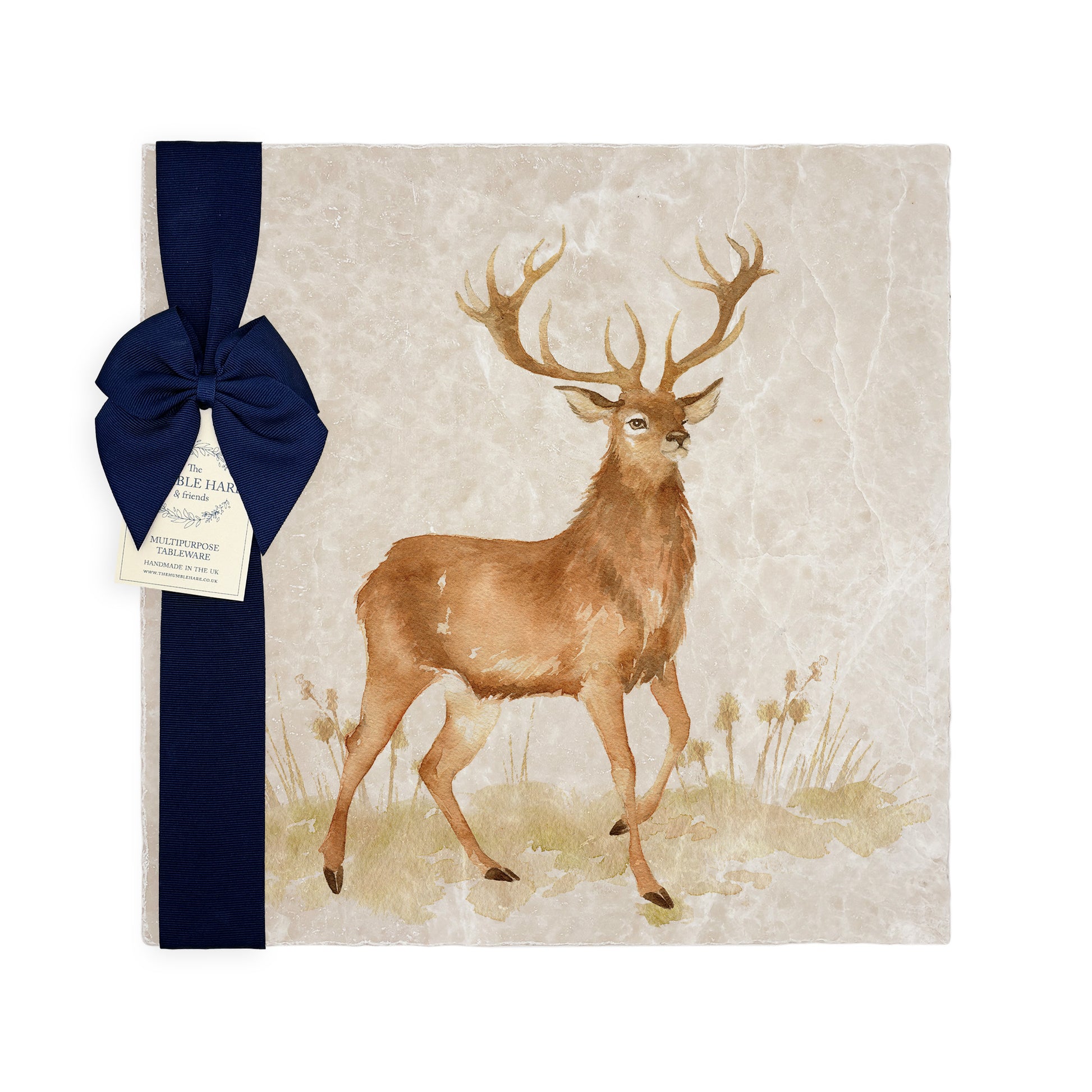 A square medium marble platter featuring a majestic stag in a watercolour style, packaged with a luxurious blue bow and gift tag.