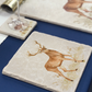 A handmade medium marble platter featuring a majestic stag in a watercolour style. The platter is set on a Christmas dinner table to be used as a side plate.