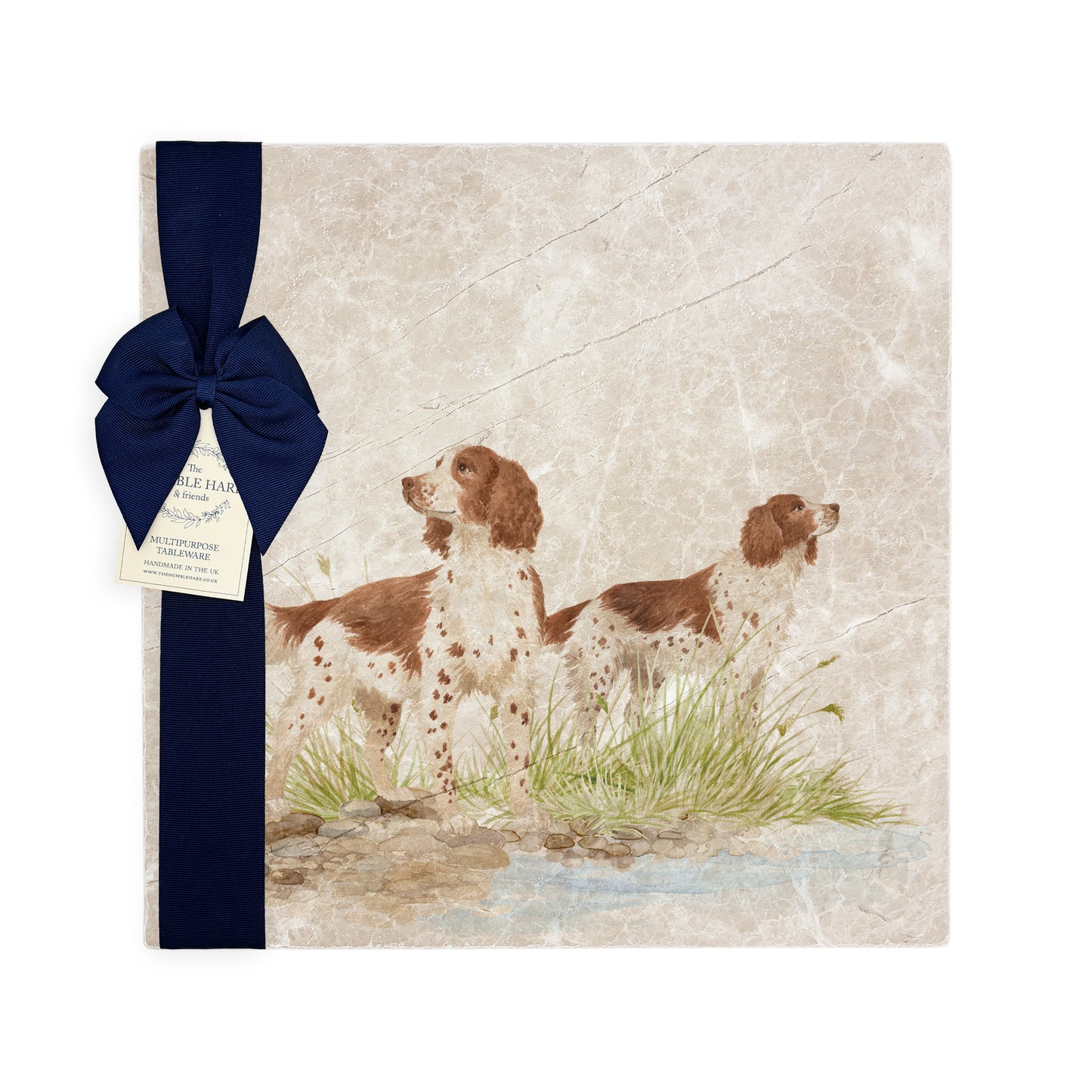 A square large marble platter featuring a watercolour design of two working spaniel dogs. The platter is packaged with a luxurious blue gift bow.
