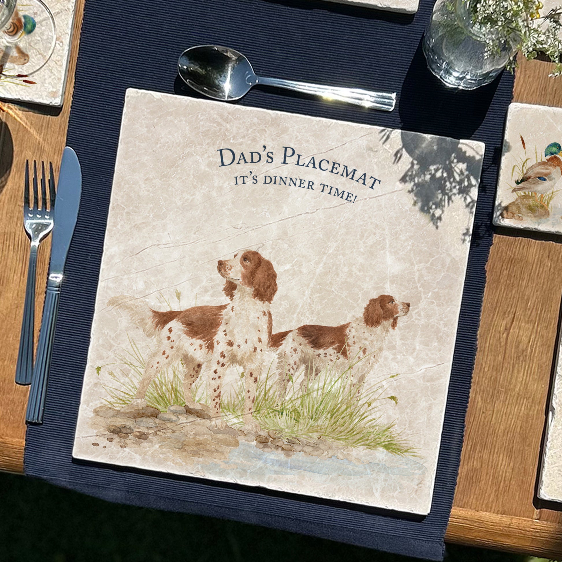A square medium marble platter featuring a watercolour design of two working spaniel dogs, personalised with custom text.