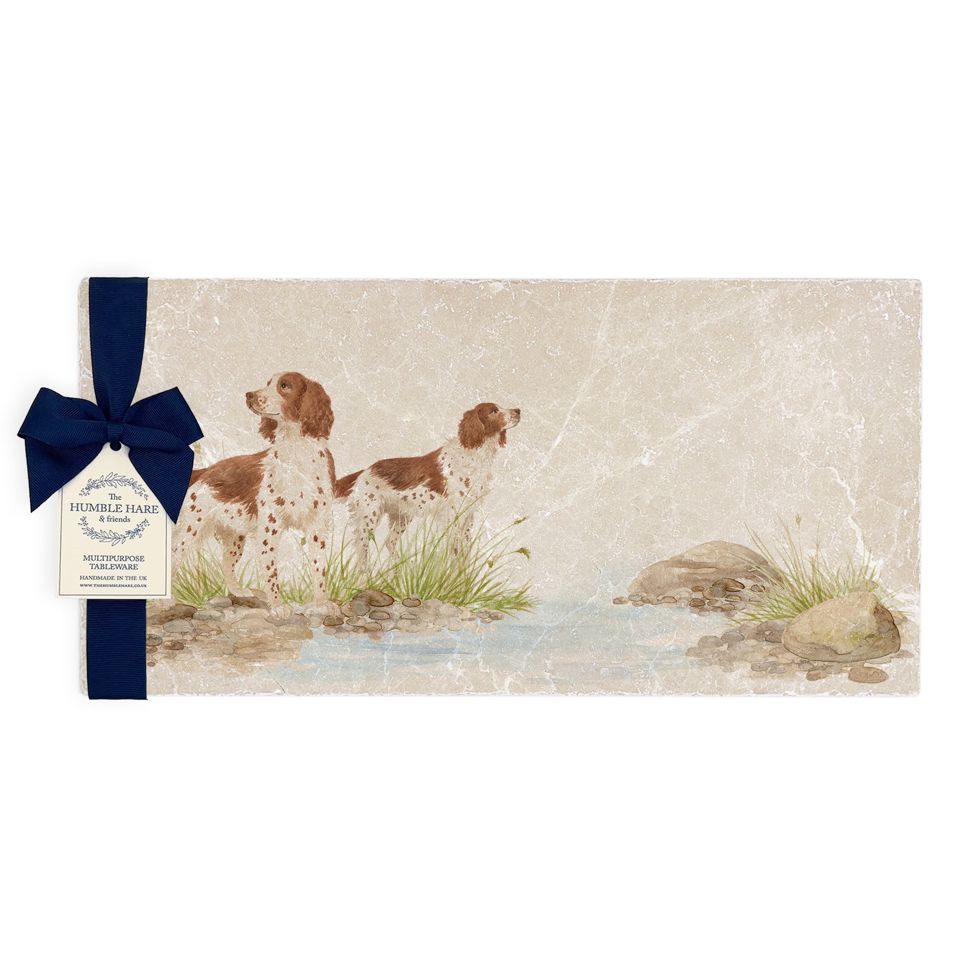 A rectangular marble sharing platter featuring a watercolour design of two working spaniel dogs. The platter is packaged with a luxurious blue gift bow.