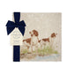 A square medium marble platter featuring a watercolour design of two working spaniel dogs. The platter is packaged with a luxurious blue gift bow.