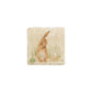 A 10x10cm cream marble splashback tile with a watercolour design featuring a hare washing his ear.