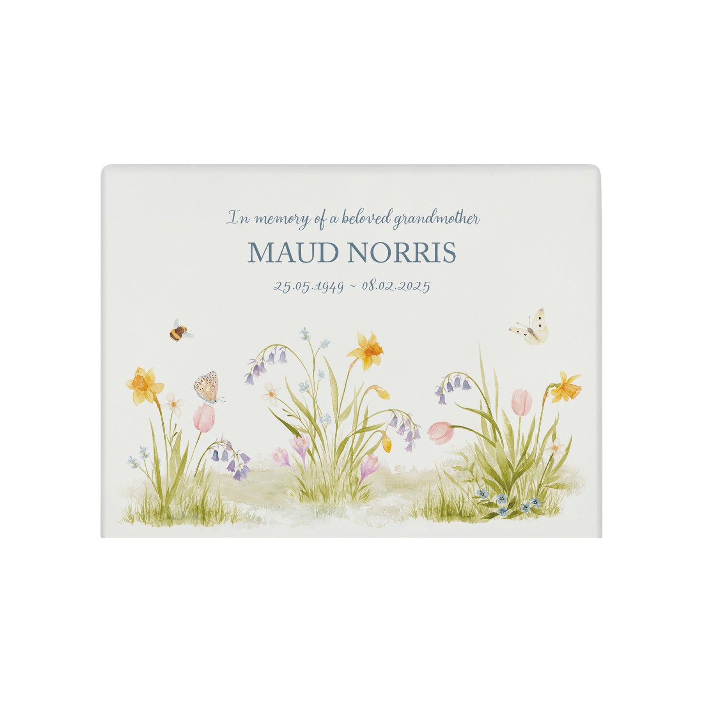 A beautifully crafted solid wooden urn, finished in white with a soft watercolour design with Spring flowers, Bees and Butterflies,. Thoughtfully made for either display or burial, this personalised urn can be customised to create a meaningful memorial. Perfect for holding ashes of a loved one or a beloved pet, it serves as a comforting tribute and keepsake.