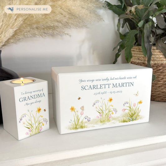 A beautifully crafted solid wooden urn, finished in white with a soft watercolour design of a Spring Garden with Bees and Butterflies, Thoughtfully made for either display or burial, this personalised urn can be customised to create a meaningful memorial. Perfect for holding ashes of a loved one or a beloved pet, it serves as a comforting tribute and keepsake.