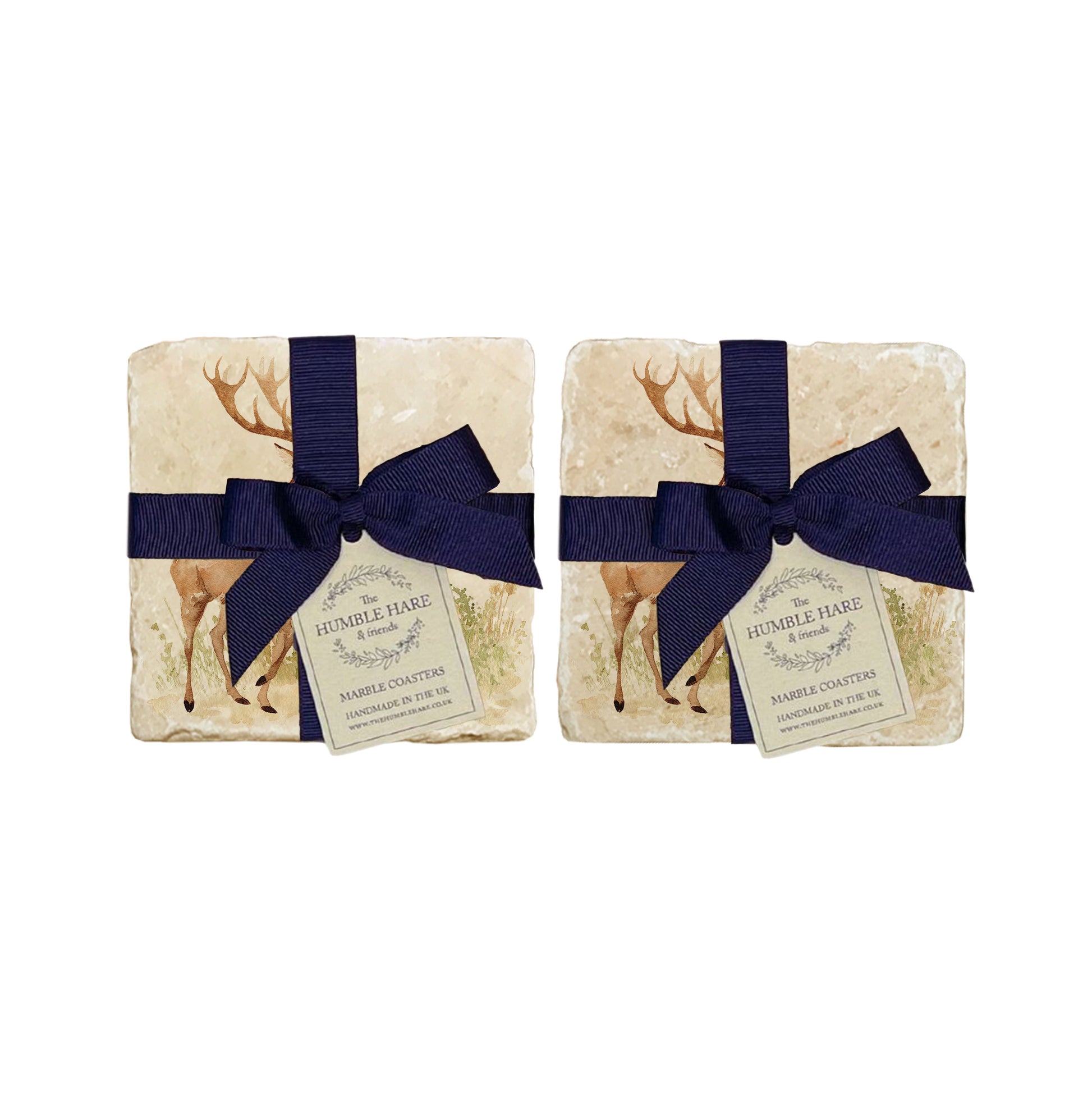 A set of 4 handmade marble coasters packaged in 2 pairs, with a luxurious blue bow and gift tag. The coasters feature a watercolour design of a red deer stag and hind.