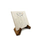 A medium marble keepsake platter on a wooden stand.