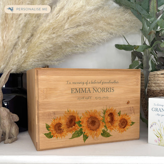 A beautifully crafted solid Bamboo wooden urn, personalised and finished with a soft watercolour design of Sunflowers and buzzy bees.  Thoughtfully made for either display or burial, this personalised urn can be customised to create a meaningful memorial. Perfect for holding ashes of a loved one or a beloved pet, it serves as a comforting tribute and keepsake. 