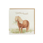 A greetings card reading Thanks a Bunch in brown text above a chestnut Shetland pony holding a bunch of flowers in a watercolour style. The card has a recyclable brown kraft envelope behind it.