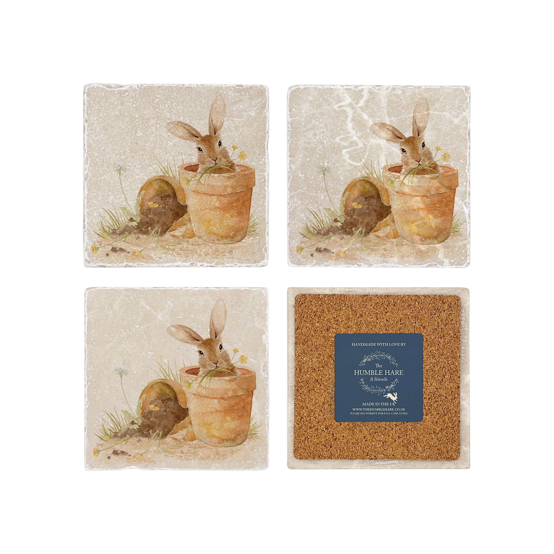 A set of four marble coasters featuring a watercolour design of a bunny in a terracotta flowerpot eating the spring flowers. One coaster is flipped to show that it has a cork back to protect worksurfaces.