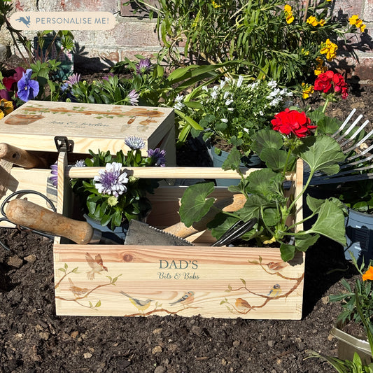 wooden luxury Trug/Caddy the perfect personalised gift. Each product is lovingly designed, handmade with our Countryside inspired watercolour designs. This design featuresbirds on branches, you can see a robin, chaffinch, bluetit, wren, song thrush and sparrow. This product is set in a flower bed showing what you can use the trug for- The perfect flower carrier , tool carrier, beer carrier, tool carrier, a unique designs for a truly one off special occasion for a loved one. 