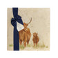 A multipurpose marble platter with a highland cow and calf design, packaged with a luxurious dark blue bow and branded gift tag.