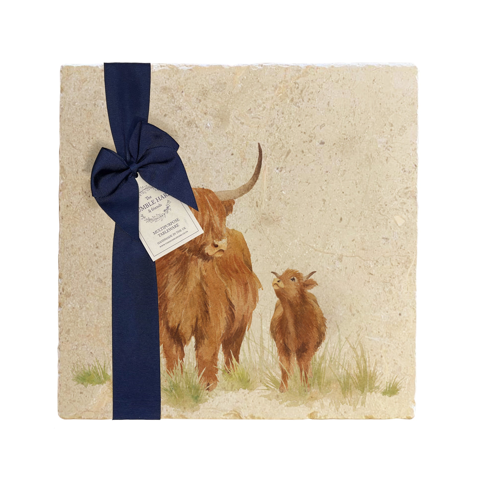 A multipurpose marble platter with a highland cow and calf design, packaged with a luxurious dark blue bow and branded gift tag.