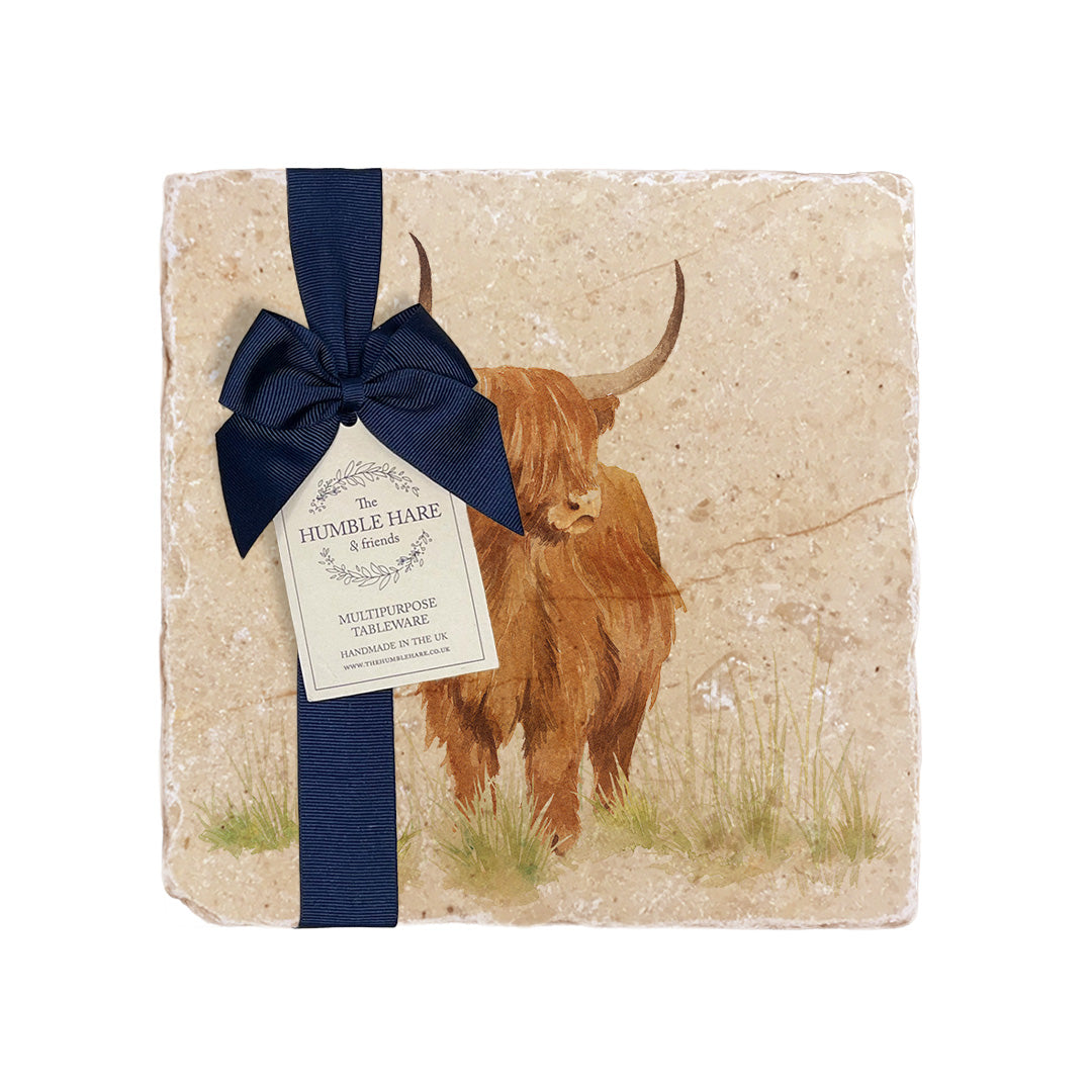 A medium multipurpose marble platter with a highland cow design, packaged with a luxurious dark blue bow and branded gift tag.