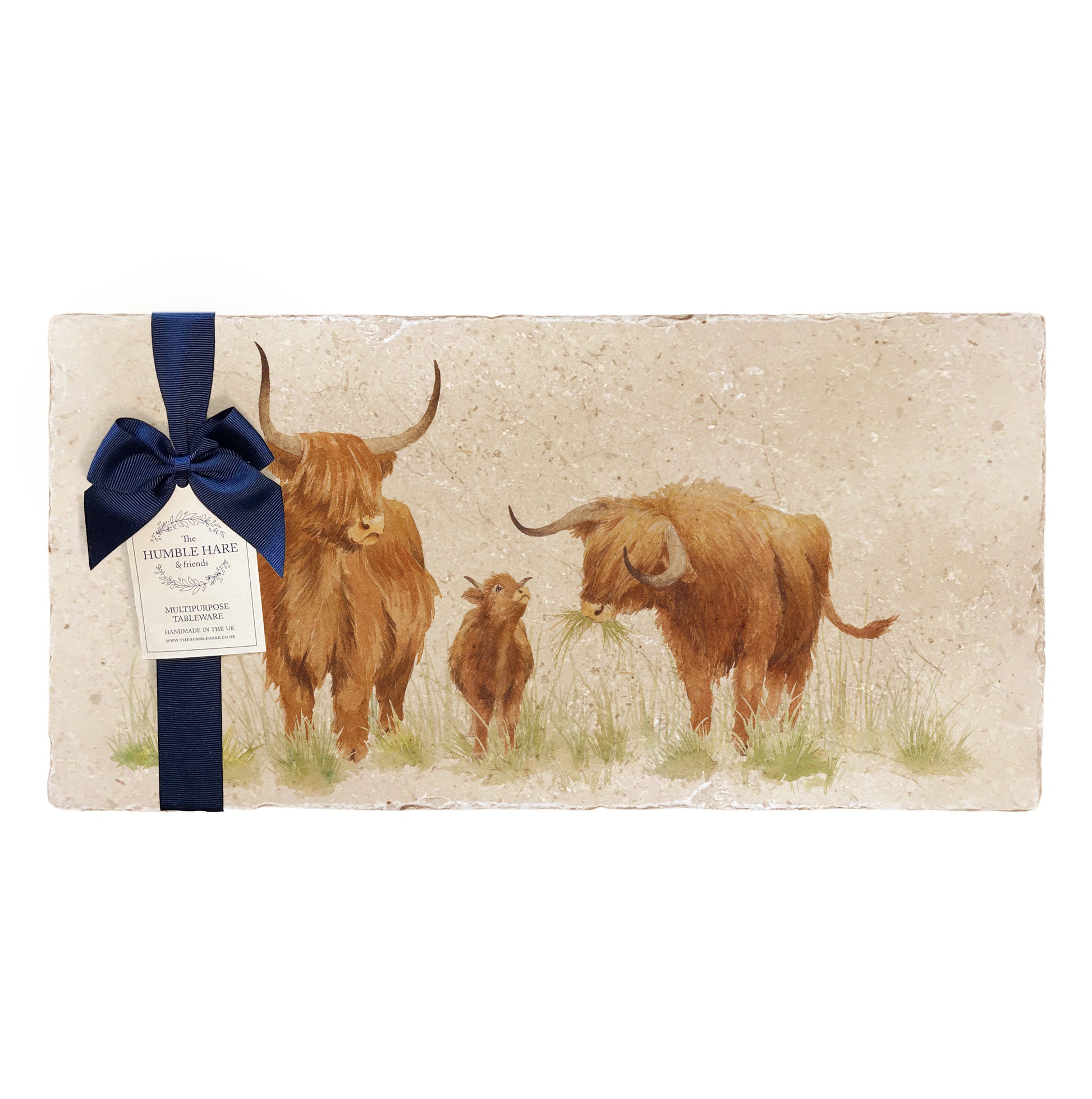 A multipurpose marble sharing platter with a highland cow and calf design, packaged with a luxurious dark blue bow and branded gift tag.