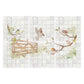 A decorative kitchen backsplash tile featuring a watercolour vintage-style illustration of birds perched on branches and a wooden fence, installed on a light grey tiled wall above a black stovetop in a styled kitchen setting.