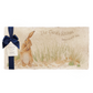 A personalised marble sharing platter featuring a hare washing his ear in a watercolour style, packaged with a luxurious dark blue bow and branded gift tag.