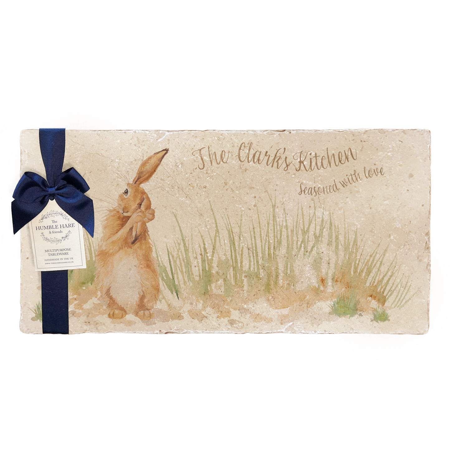 A personalised marble sharing platter featuring a hare washing his ear in a watercolour style, packaged with a luxurious dark blue bow and branded gift tag.