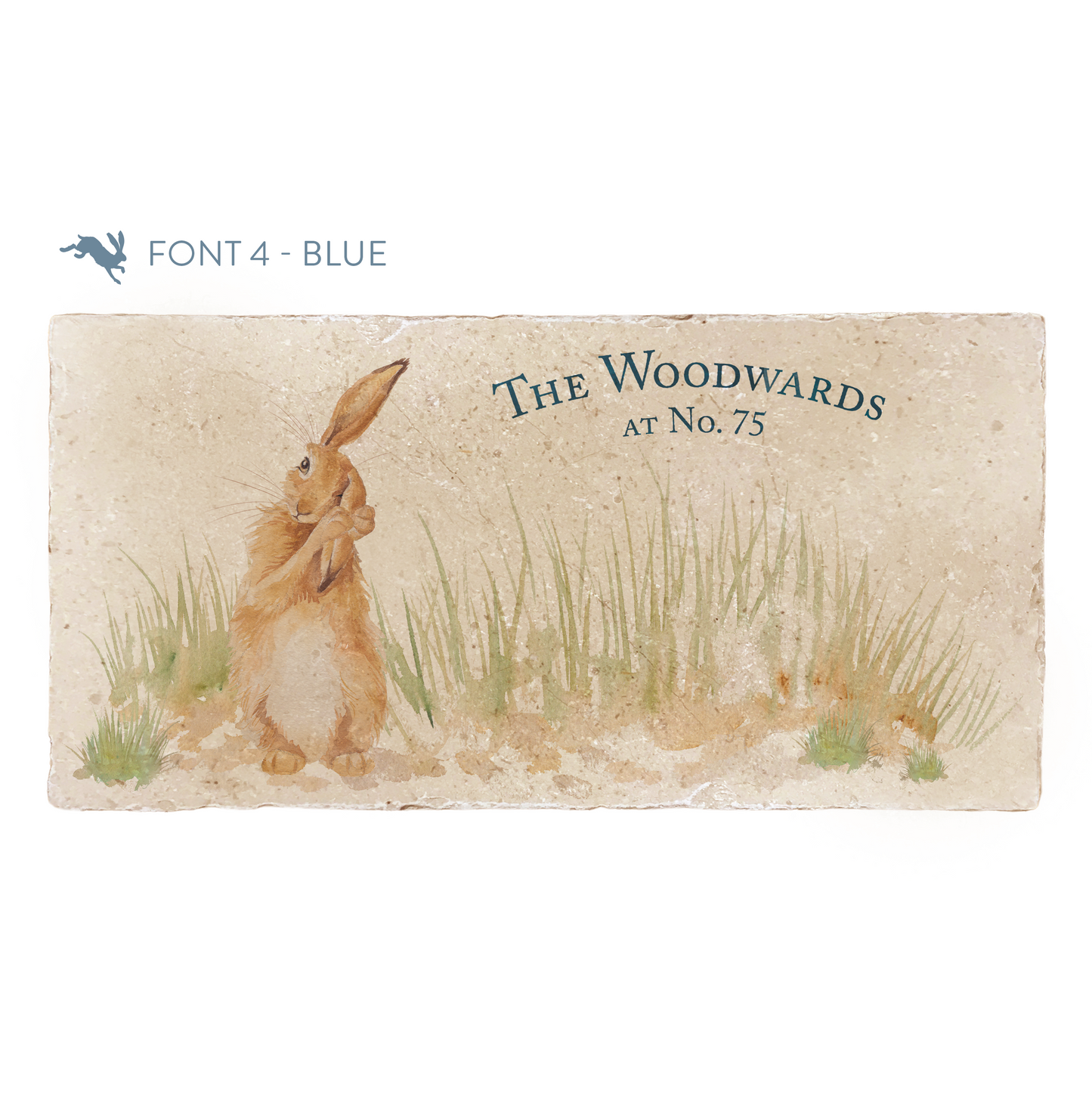 A personalised rectangular marble sharing platter featuring a hare washing his ear in a watercolour style. The example personalised dark blue text reads ‘The Woodwards at No. 75’ in a classic serif font.