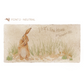 A personalised rectangular marble sharing platter featuring a hare washing his ear in a watercolour style. The example personalised neutral colour text reads ‘J&R’s New Home, 26th September 2023’ in an elegant script font.