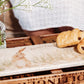 A personalised marble sharing platter featuring a hare washing his ear, set on a coffee table to serve pastries. The personalised text reads 'Mum's Favourite'.