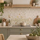 Mosaic tiles featuring a delicate watercolour-style illustration of wildflowers, bees, and a beehive on a white and light grey tile grid background.