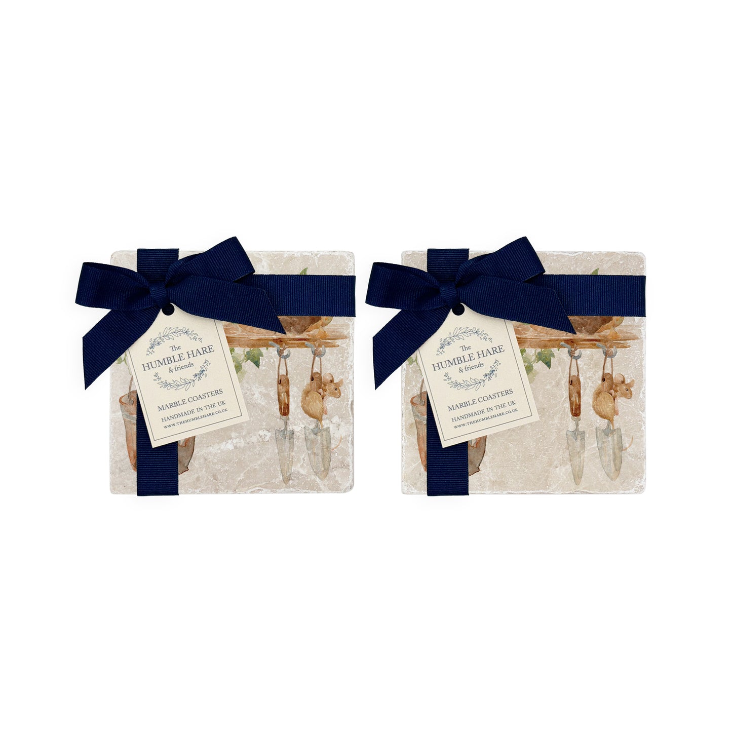 A set of four marble coasters featuring a  watercolour design of mice in a garden shed among the flowerpots and tools. The coasters are packaged with a blue bow and gift tag.