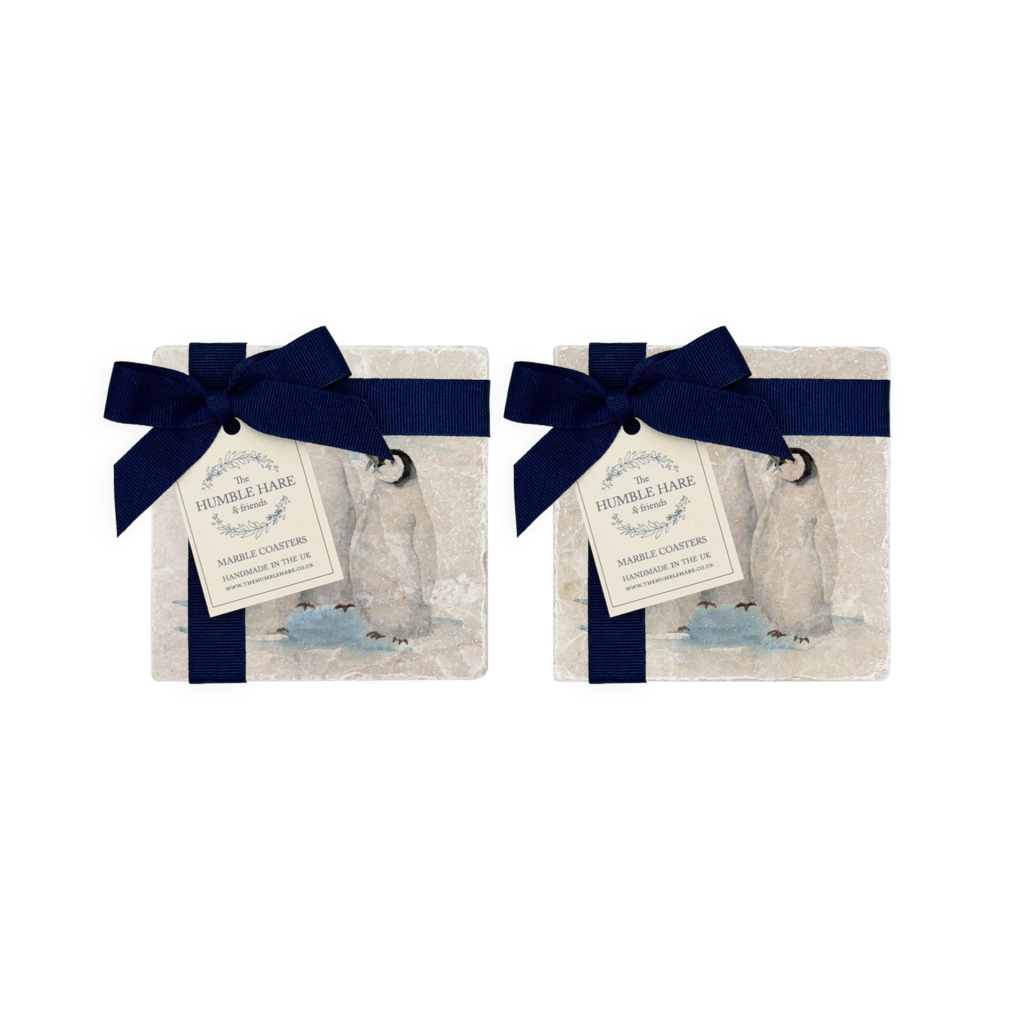The Penguin Huddle Design features a set of 4 marble coasters with three penguins huddled together. One cheeky penguin has caught a fish to show his friends. The perfect finished with The Humble Hare signature blue ribbon and tag. 