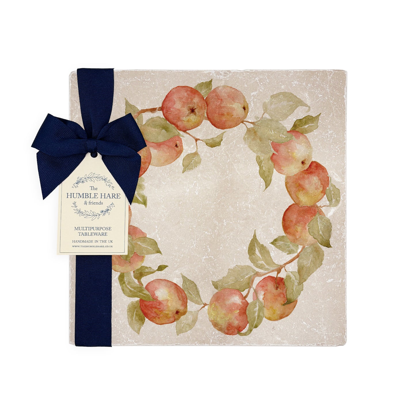A medium square marble platter featuring a watercolour apple wreath design. The platter is set on a dinner table next to a marble placemat and coaster.