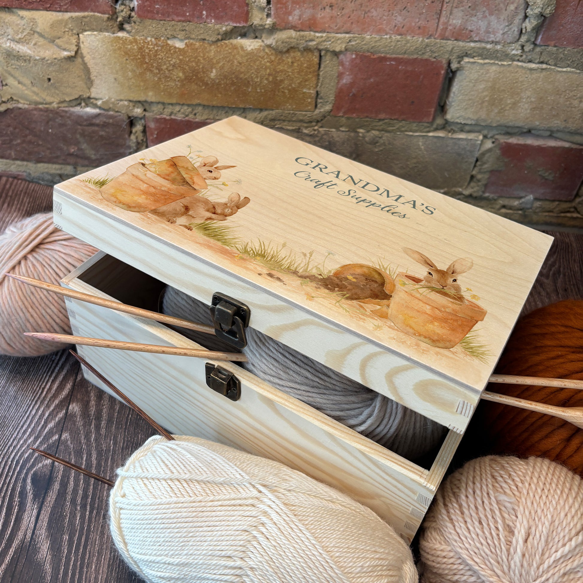 Medium wooden pine gift box, The perfect Personalised keepsake, memory box, storage box with lots of Bunnies ain pots holding bunches of flowers in their mouths in a classic  gentle watercolour style. Perfect for storing your knitting and and sewing equipment in. Best way to get organised