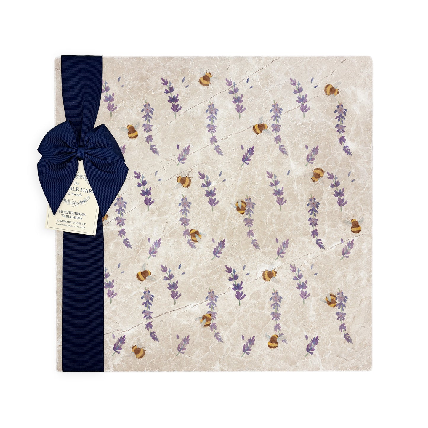 A large multipurpose marble platter with a watercolour bee and lavender flower pattern, packaged with a luxurious dark blue bow and branded gift tag.