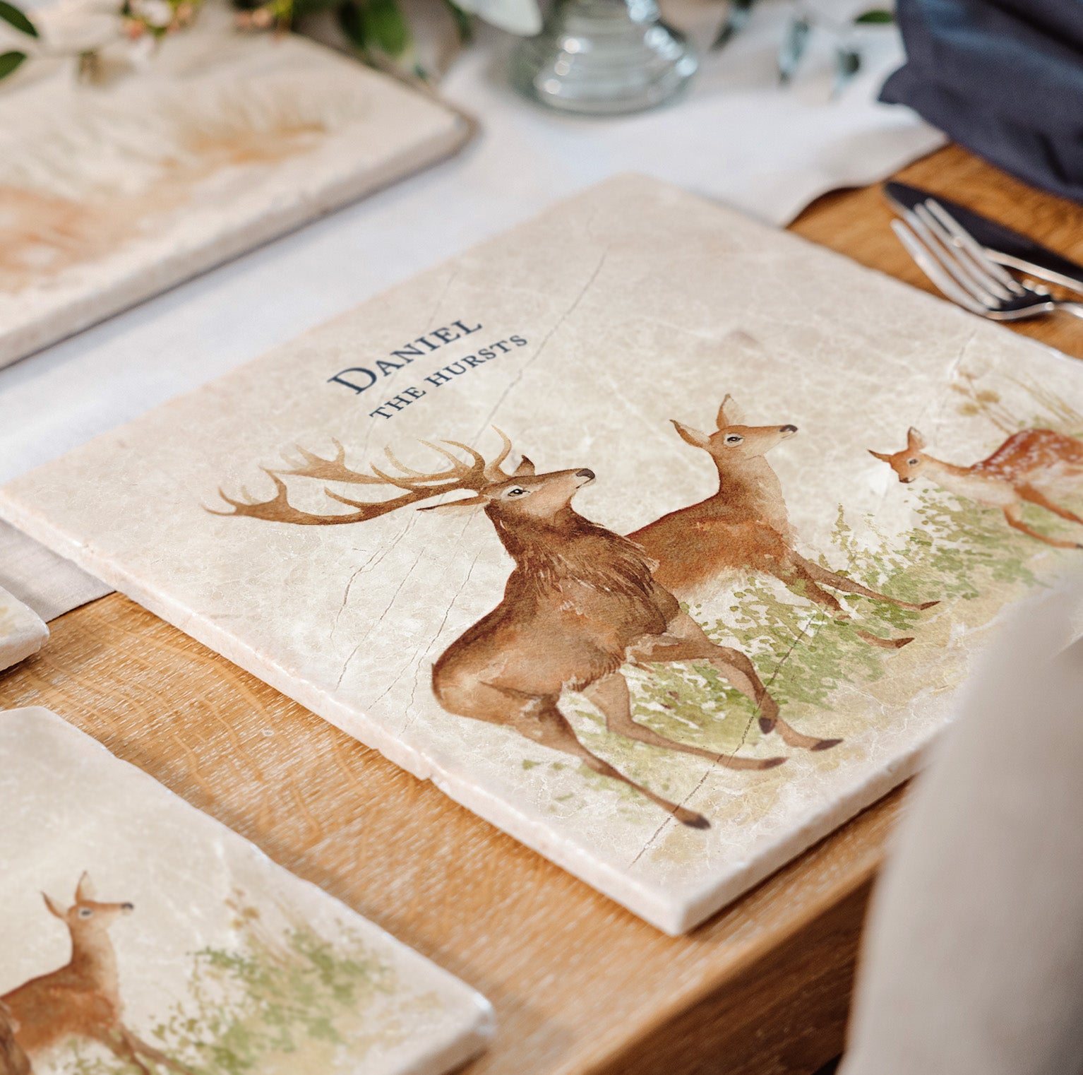 A personalised marble large platter with a family of red deer and fawns watercolour design. Create a personalised placemat, serving platter, trivet or cheeseboard as a luxury gift.