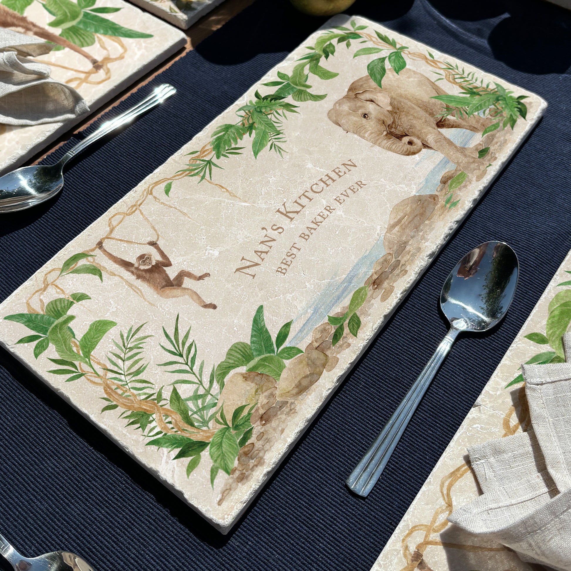 A personalised marble sharing platter with an Asian elephant and gibbon rainforest watercolour design. Create a personalised serving platter, trivet or cheeseboard as a luxury gift.