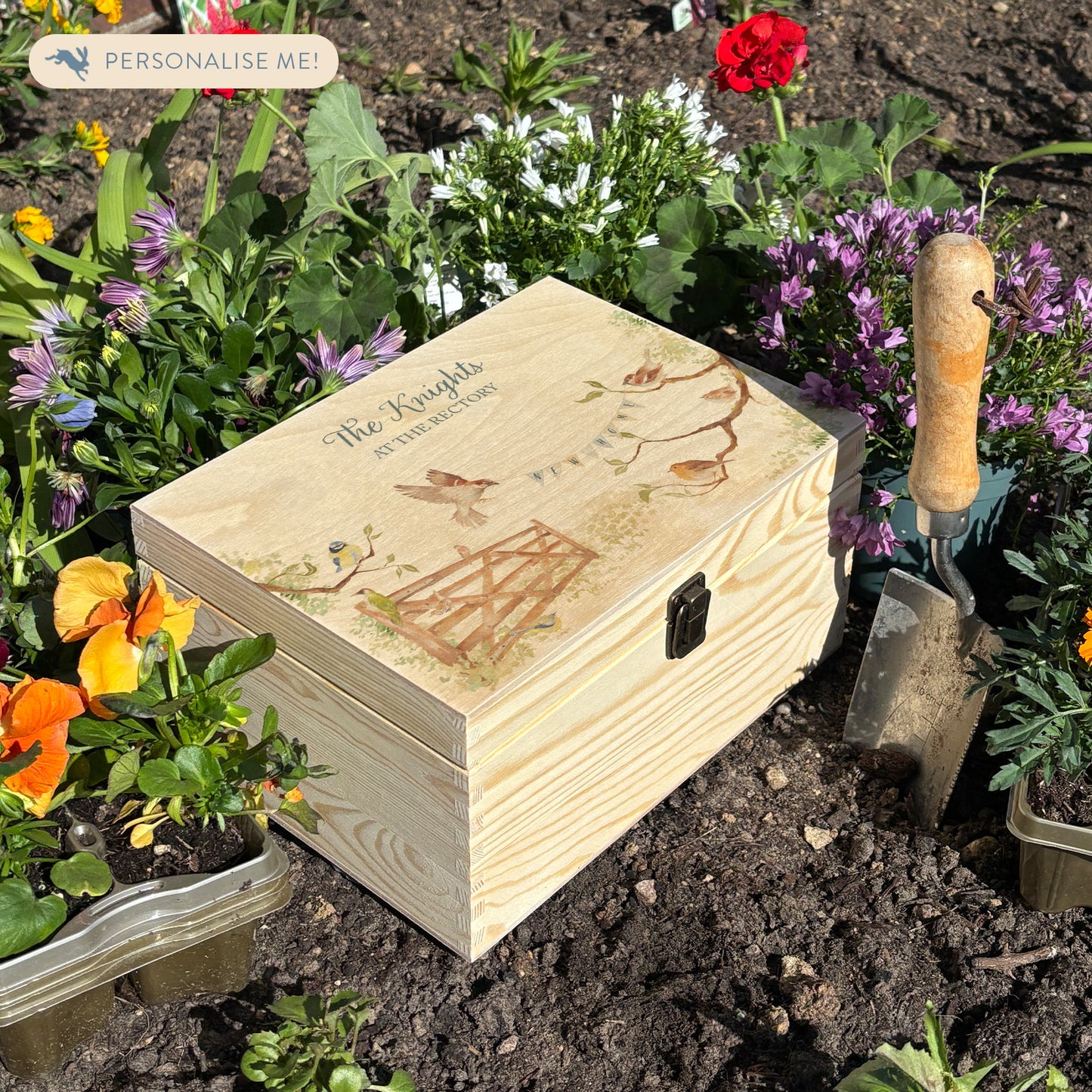 This medium sized wooden pine New home gift box can be filled with special gifts as a new home special occasion. The Design has a blue tit, robin, wren and sparrow on branches. There is a flying sparrow carrying a new home bunting. There is also a beautiful wooden gate opening to symbolise new beginnings with the gate opening. In the Garden new home gift.