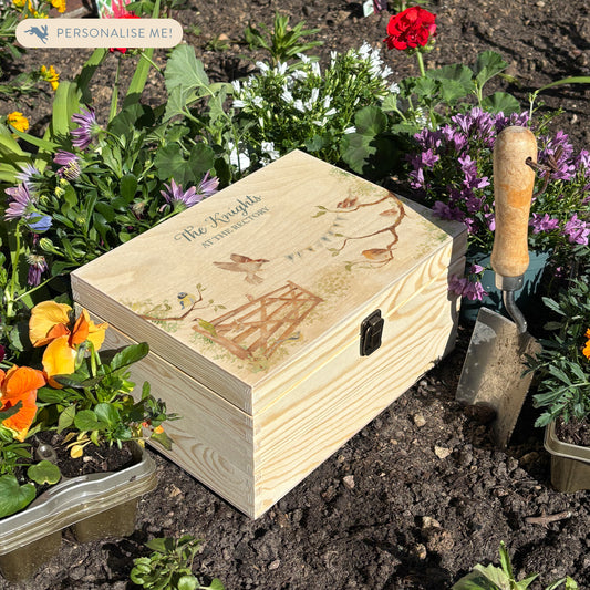 This medium sized wooden pine New home gift box can be filled with special gifts as a new home special occasion. The Design has a blue tit, robin, wren and sparrow on branches. There is a flying sparrow carrying a new home bunting. There is also a beautiful wooden gate opening to symbolise new beginnings with the gate opening. In the Garden new home gift.