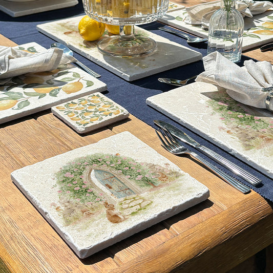 A square medium marble platter featuring a watercolour scene of animals showing the way to a hidden door leading to a secret garden.