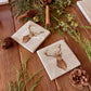 A set of four marble coasters with a watercolour illustration of a stag's head.