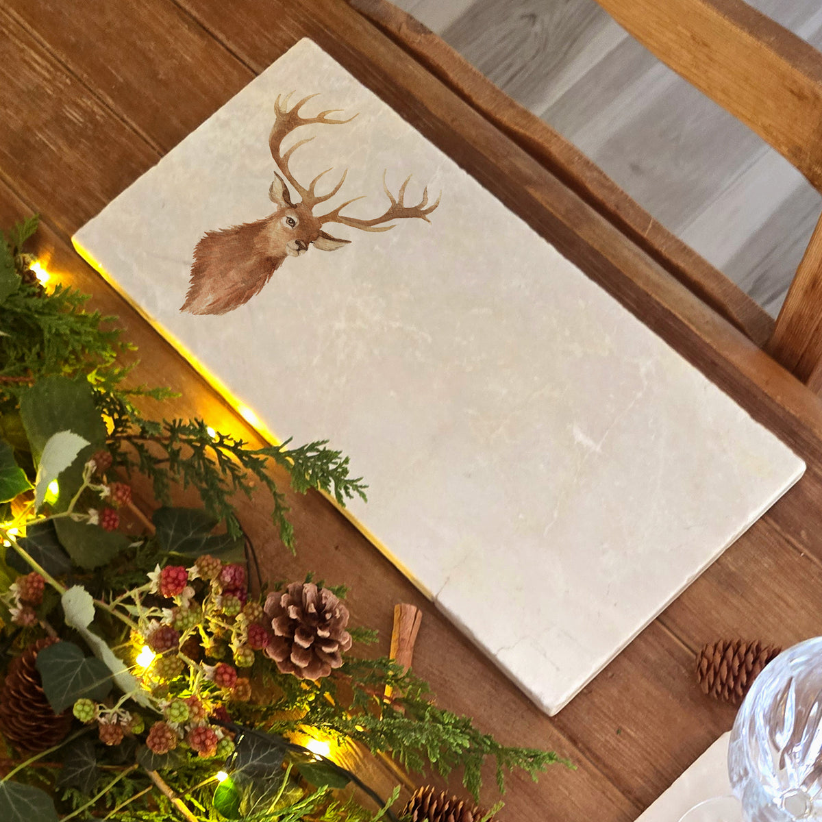A marble sharing platter featuring a watercolour portrait of a majestic stag.