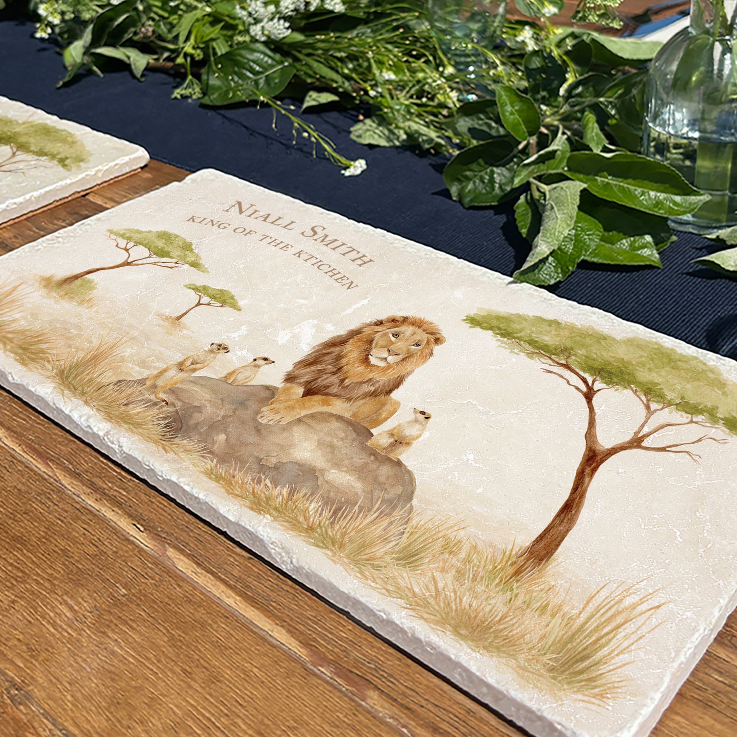 A personalised marble sharing platter with a watercolour design of a lion and meerkats in the African savannah. Create a personalised serving platter, trivet or cheeseboard as a luxury gift.