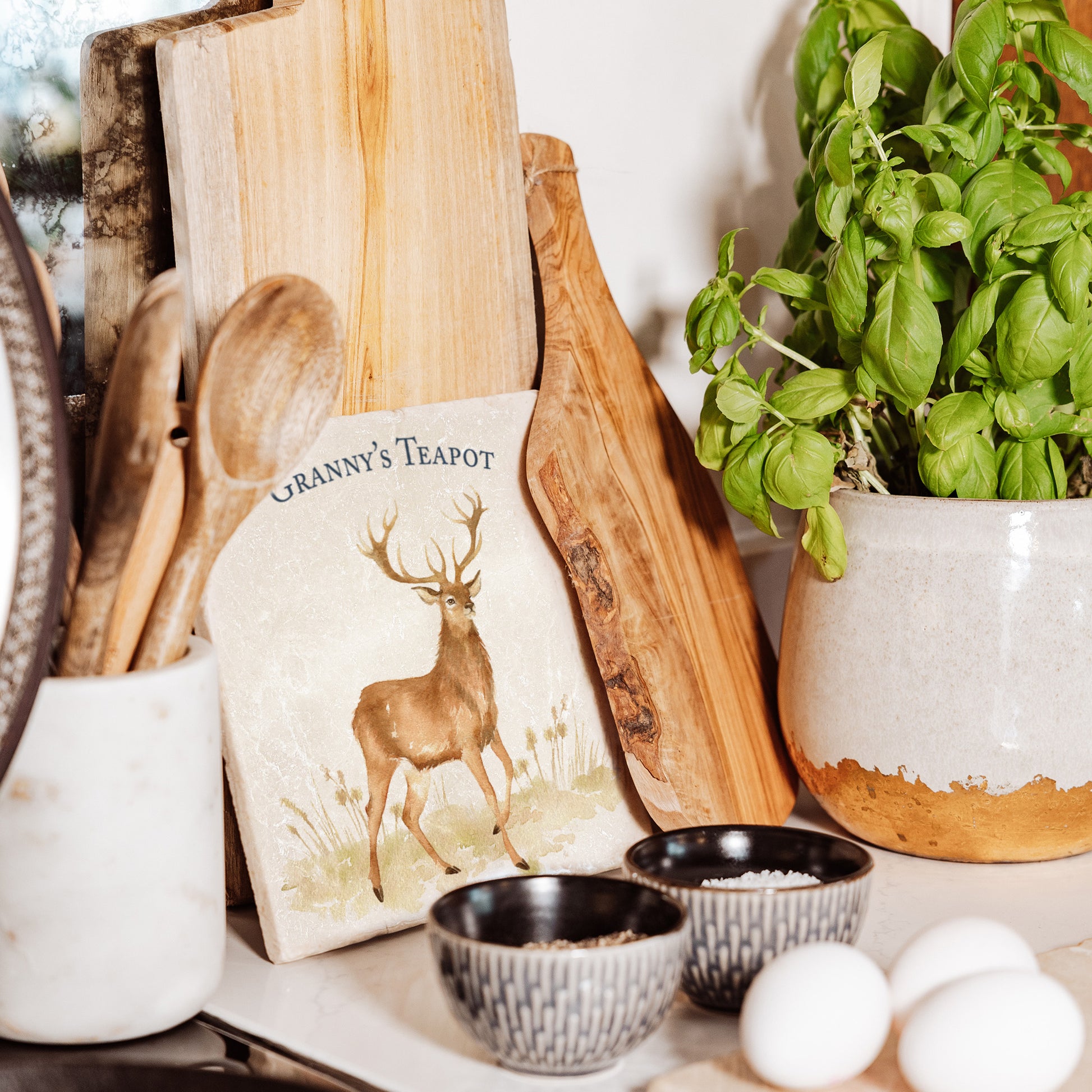 A medium personalised square marble platter featuring a majestic stag in a watercolour style. The platter is set on a table laid for Christmas dinner.