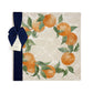 A large square marble placemat, featuring a rustic oranges and leaves wreath design.