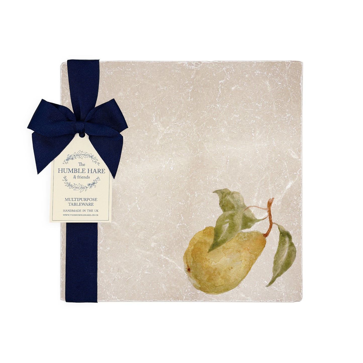 A table laid for an elegant dinner party in the garden, set with marble placemats and coasters that feature a watercolour pear design.