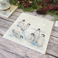 Beautiful Penguin family huddled together on our best selling Large Platter they are in a snowy Antarctica the perfect gift finished with a blue ribbon.  