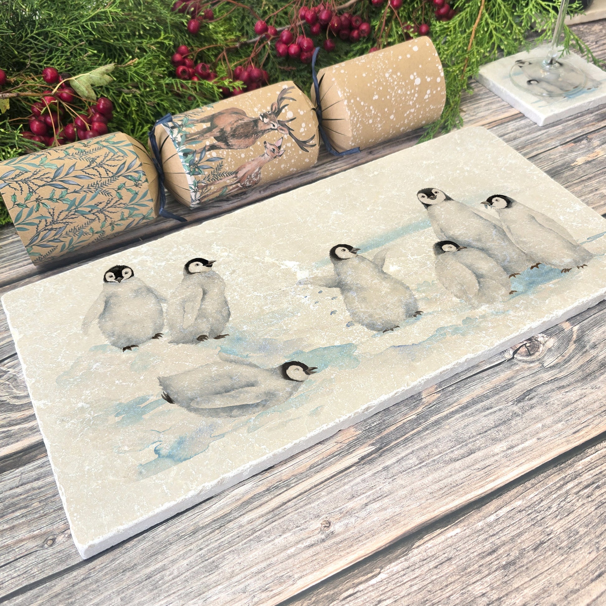 Beautiful Penguin family huddled together, with some cheeky characters having fun sliding around on their tummies, this design is on  our best selling sharing platter they are in a snowy Antarctica the perfect gift finished with a blue ribbon.  