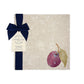 A garden table set with marble placemats and coasters that feature a watercolour plum design.