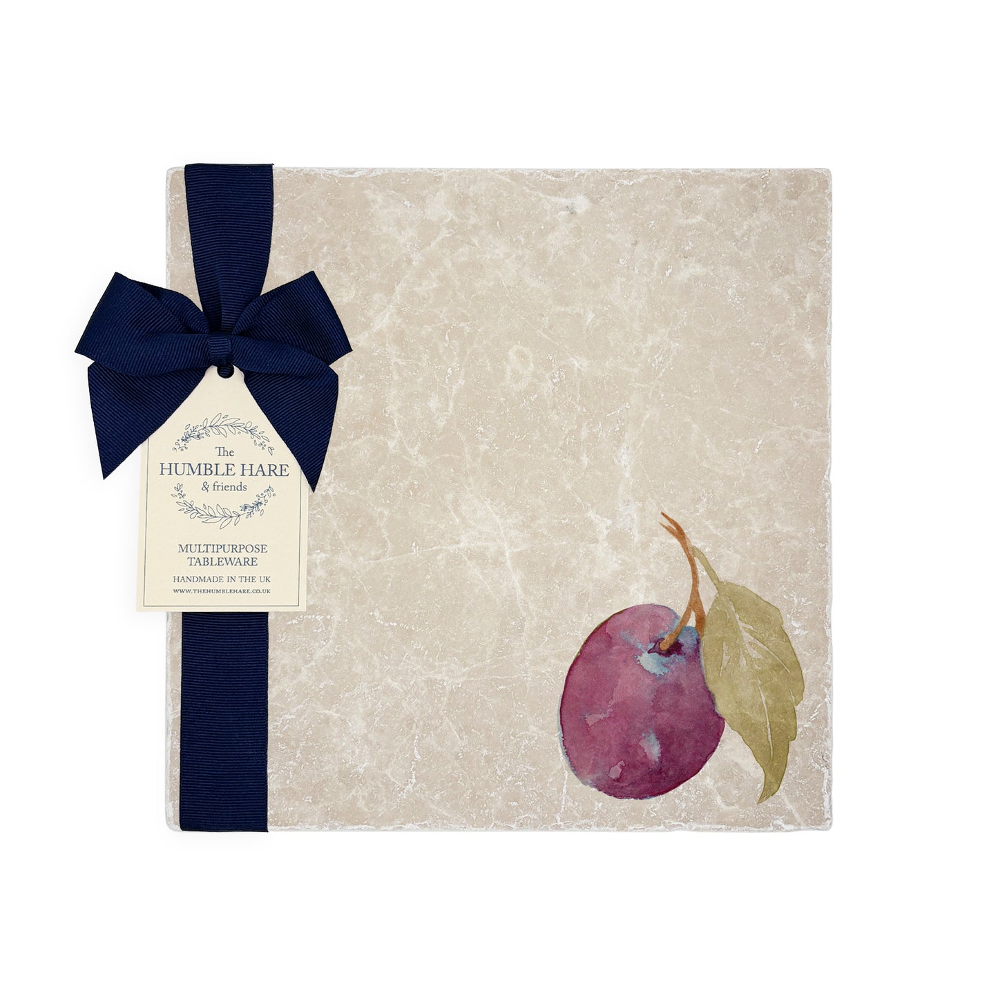 A garden table set with marble placemats and coasters that feature a watercolour plum design.